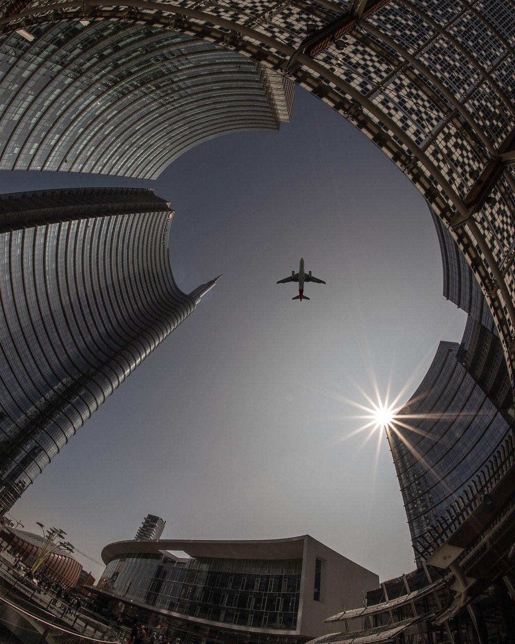 plane, city, architecture, sky, airplane, flight, travel, sun, urban, buildings, tourism, nature, outdoors, transportation, cityscape, skyline, tower, skyscrapers, lookup, aircraft